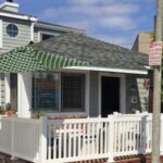 Closed-Picket-Vinyl-Railing-front-yard-with-brick-500x640