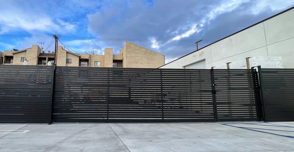 Dark Gray Aluminum Fence with a gate that is motorized.